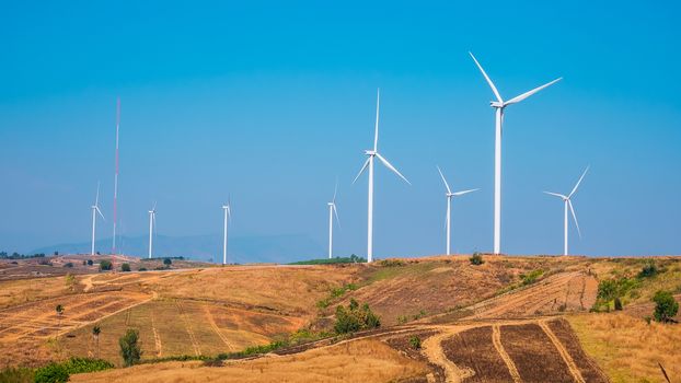 Wind turbine for electricity production on the mountains and beautiful sky.