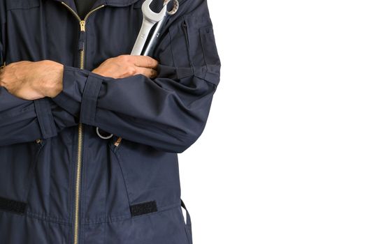 Car repairman wearing a dark blue uniform standing and holding a wrench that is an essential tool for a mechanic isolated on white background, Automotive industry and garage concepts.