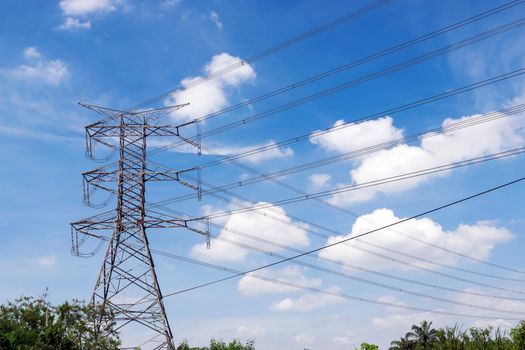 Closeup the high voltage towers with clouds sky and sun background.