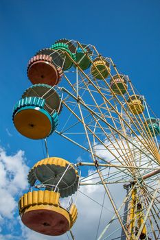 Old fashioned ferris wheel. Rusty ferris wheel. Panoramic wheel. Old carousel in an undeveloped country. Not a safe attraction.