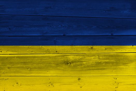 Ukraine flag painted on old wood plank. Patriotic background. National flag of Ukraine