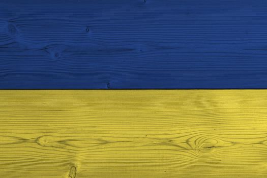 Ukraine flag painted on old wood plank. Patriotic background. National flag of Ukraine