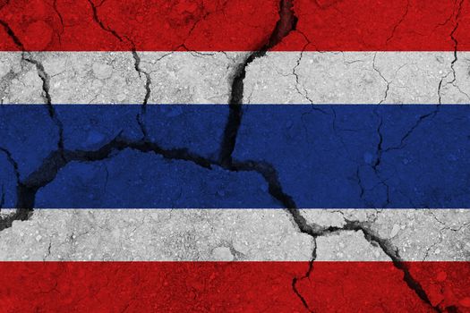 Thailand flag on the cracked earth. National flag of Thailand. Earthquake or drought concept