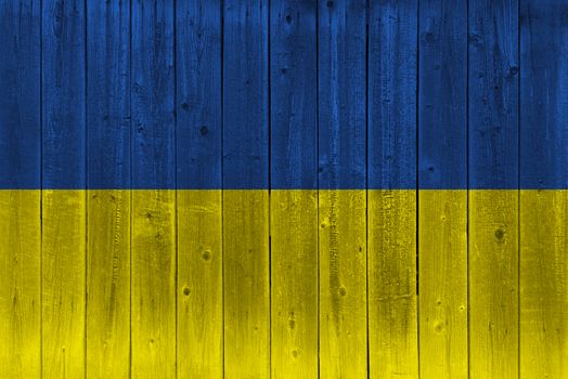 Ukraine flag painted on old wood plank. Patriotic background. National flag of Ukraine