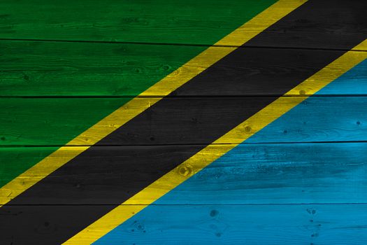 Tanzania flag painted on old wood plank. Patriotic background. National flag of Tanzania