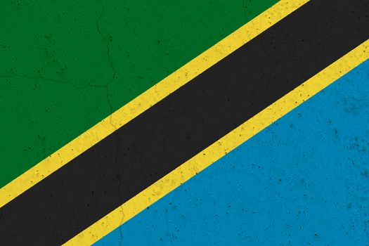 Tanzania flag on concrete wall. Patriotic grunge background. National flag of Tanzania