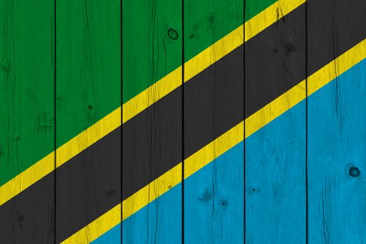 Tanzania flag painted on old wood plank. Patriotic background. National flag of Tanzania