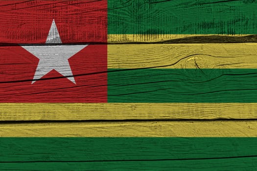 Togo flag painted on old wood plank. Patriotic background. National flag of Togo