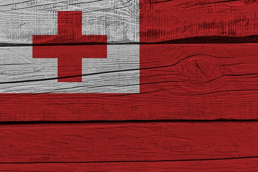 Tonga flag painted on old wood plank. Patriotic background. National flag of Tonga