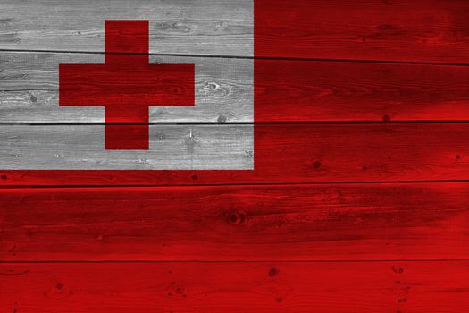 Tonga flag painted on old wood plank. Patriotic background. National flag of Tonga