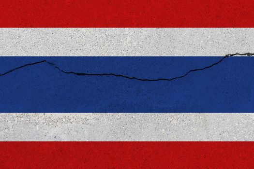 Thailand flag on concrete wall with crack. Patriotic grunge background. National flag of Thailand
