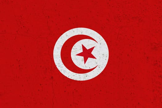 Tunisia flag on concrete wall. Patriotic grunge background. National flag of Tunisia