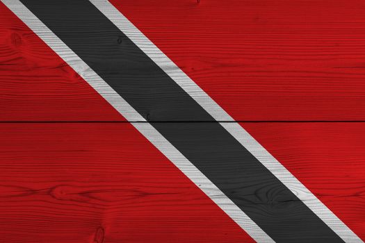 Trinidad and Tobago flag painted on old wood plank. Patriotic background. National flag of Trinidad and Tobago