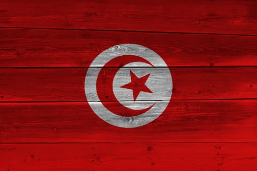 Tunisia flag painted on old wood plank. Patriotic background. National flag of Tunisia