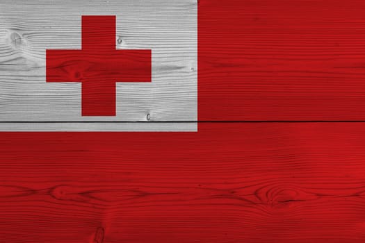 Tonga flag painted on old wood plank. Patriotic background. National flag of Tonga