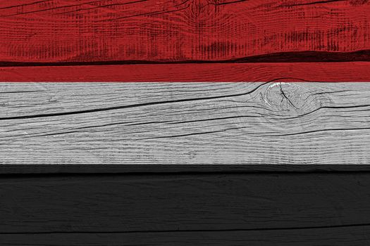 Yemen flag painted on old wood plank. Patriotic background. National flag of Yemen