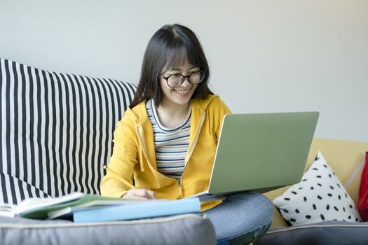 Young collage student using computer and mobile device studying online. Education and online learning. 