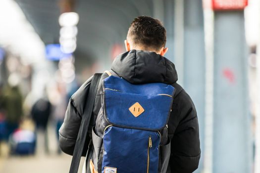 Young man with backpack on the train platform of Bucharest North Railway Station (Gara de Nord Bucharest) in Bucharest, Romania, 2020