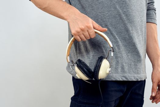 Man holding headphones in the hands of a man lifestyle modern style technology cropped view. High quality photo