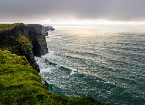  View of the Cliff of Moher in stormy weather and low clouds, Ireland.