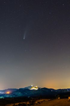 Neowise Comet captured from Sicily on the 23rd of July on the sky above the illuminated town of Sutera 