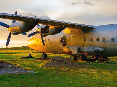 old Soviet military airplane, sunset time. Abandoned Historic Aircraft. Close up of propeller engine. Copy space