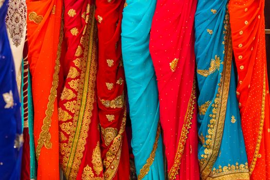 Close up of colourful and decorated Indian dresses in a market