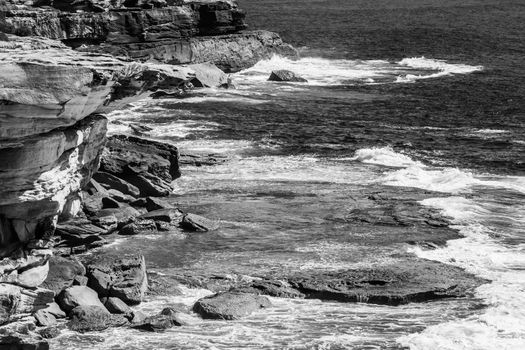 Black and white close up of the coastline and rocks captured from the Coogee to Bondi walk, Sydney, Australia