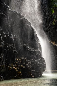 View of basalt rocks, waterfalls and pristine water of Alcantara gorges in Sicily, Italy