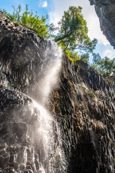 View of basalt rocks, waterfalls and pristine water of Alcantara gorges in Sicily, Italy