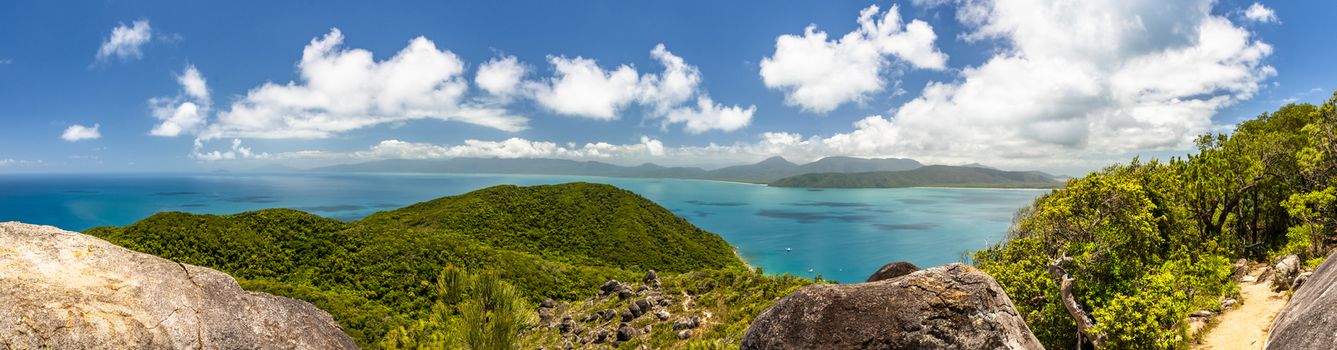 Panorama from the top of the tropical Fitzroy Island surrounded by the barrier reef. Vivid colours of a sunny day with blue sky. Queensland, Australia