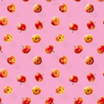 Seamless pattern with ripe apples. Apple seamless pattern on pink background. Tropical fruit abstract background.