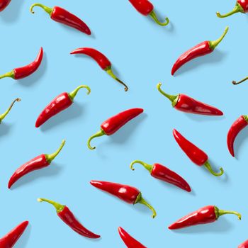 Red hot chilli seamless peppers pattern. Seamless pattern made of red chili or chilli on blue background. Minimal food pattern. Food background.
