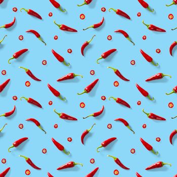 Red hot chilli seamless peppers pattern. Seamless pattern made of red chili or chilli on blue background. Minimal food pattern. Food background.