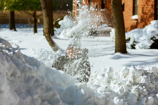 Cute little caucasian girl playing in the winter snow on a child