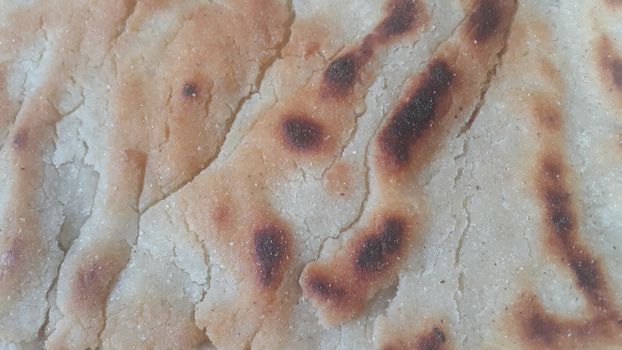 Closeup view of of traditional bread called Jawar roti or bhakri. Bhakri is a round flat unleavened bread often used in the cuisine of many Asian countries