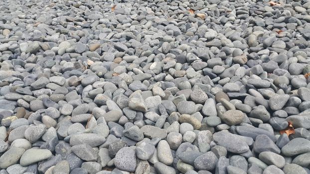 Rock Pebbles, small, rounded, smooth rocks. Texture background for text.