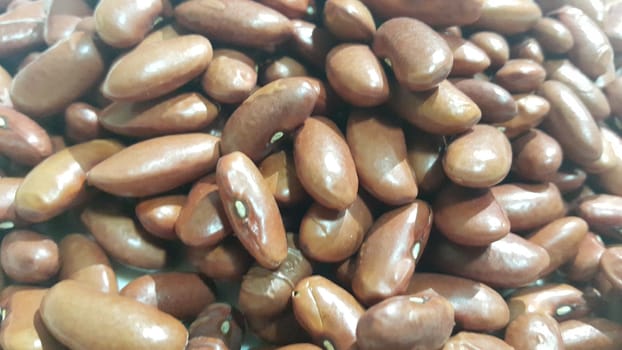 Kidenry beans:   Closeup view of uncooked red kidney beans. Dark red useful beans background.