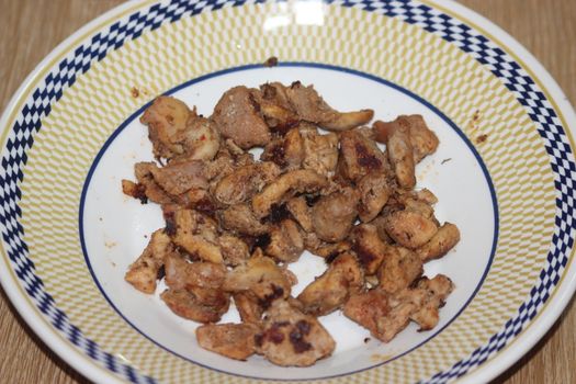 Closeup with selective focus on grilled chicken meat steaks in ceramic plate. non-vegetarian concept.