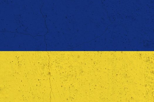 Ukraine flag on concrete wall. Patriotic grunge background. National flag of Ukraine