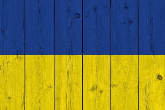 Ukraine flag painted on old wood plank. Patriotic background. National flag of Ukraine