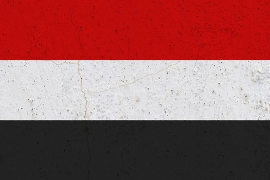 Yemen flag on concrete wall. Patriotic grunge background. National flag of Yemen