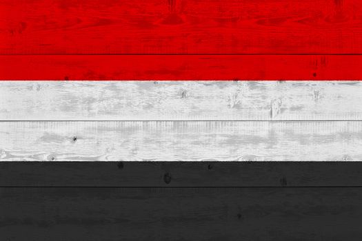 Yemen flag painted on old wood plank. Patriotic background. National flag of Yemen