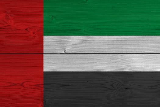 United arab flag painted on old wood plank. Patriotic background. National flag of United arab