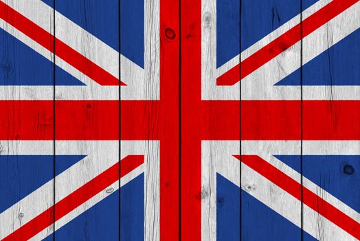 United Kingdom flag painted on old wood plank. Patriotic background. National flag of United Kingdom