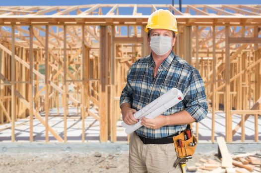 Male Contractor In Hard Hat Wearing Medical Face Mask During Coronavirus Pandemic At Construction Site.