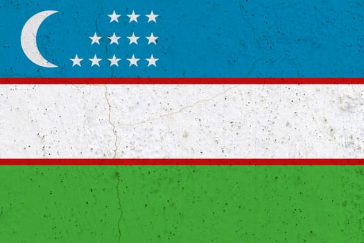 Uzbekistan flag on concrete wall. Patriotic grunge background. National flag of Uzbekistan