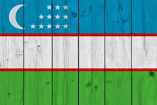 Uzbekistan flag painted on old wood plank. Patriotic background. National flag of Uzbekistan