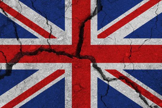 United Kingdom flag on the cracked earth. National flag of United Kingdom. Earthquake or drought concept