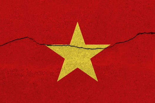 Vietnam flag on concrete wall with crack. Patriotic grunge background. National flag of Vietnam